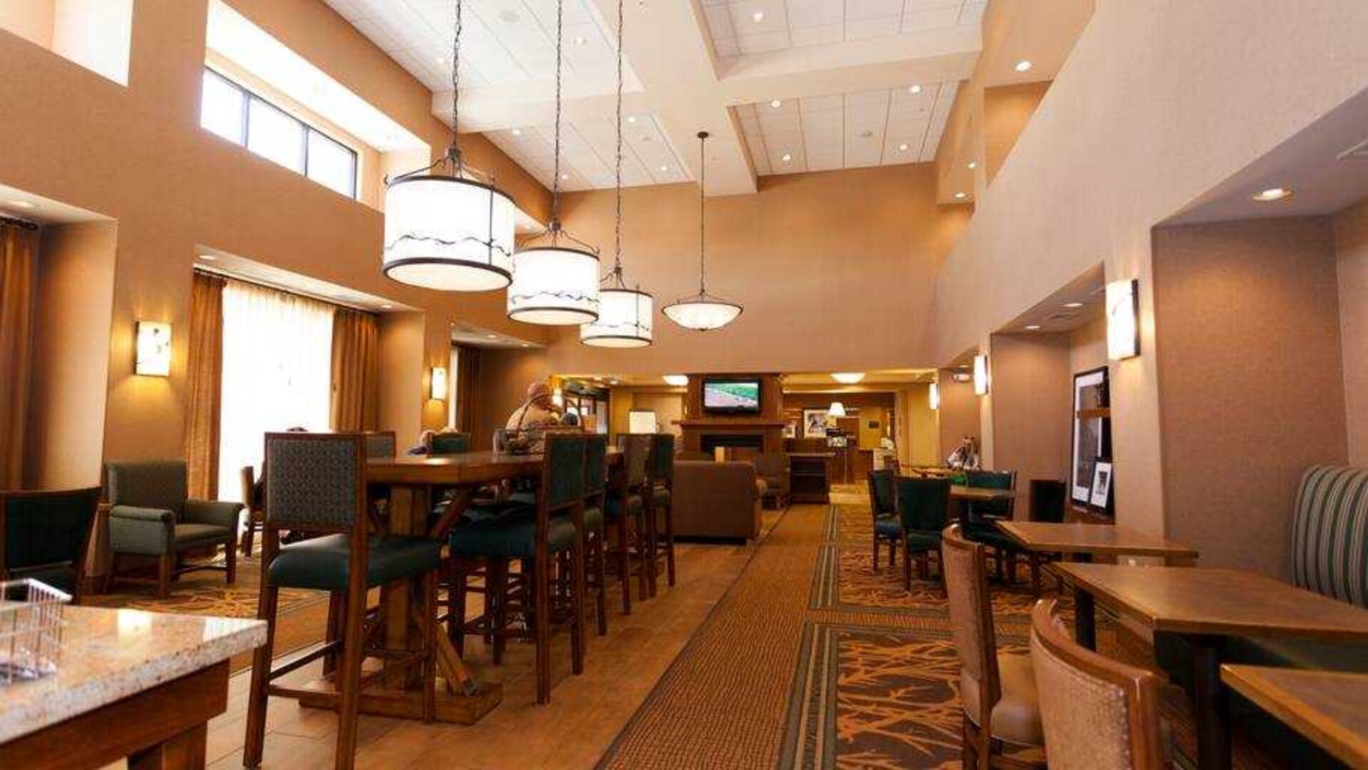 Restaurant area with chairs and tables perfect as workplace at the Hampton Inn & Suites Riverton, WY.