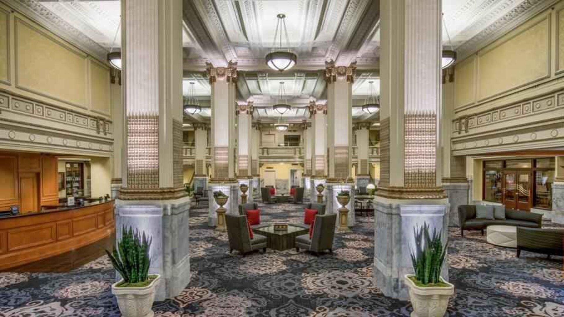 Elegant lobby area with tables and chairs perfect as workspace at the Embassy Suites by Hilton Portland-Downtown.