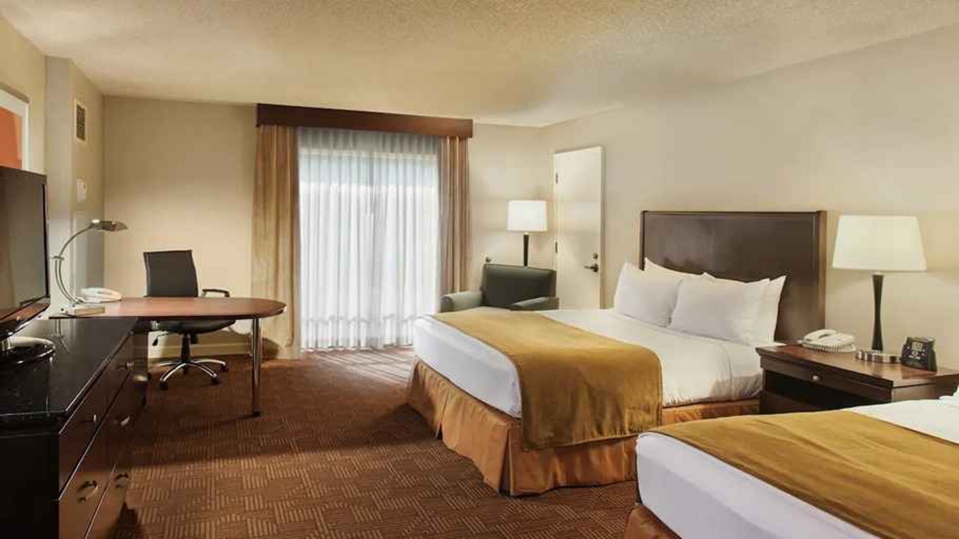 beautiful queen bedroom work desk and TV at DoubleTree by Hilton Hotel Sacramento.