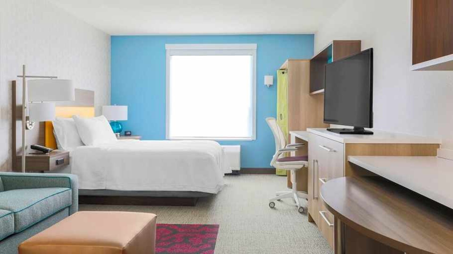 Day room with TV and work station at Home2 Suites By Hilton West Sacramento.