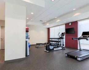 well-equipped fitness center with natural light at Home2 Suites by Hilton West Sacramento.