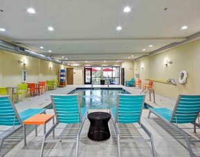 Relaxing indoor pool with seating area at Home2 Suites by Hilton Fort Worth Southwest Cityview.