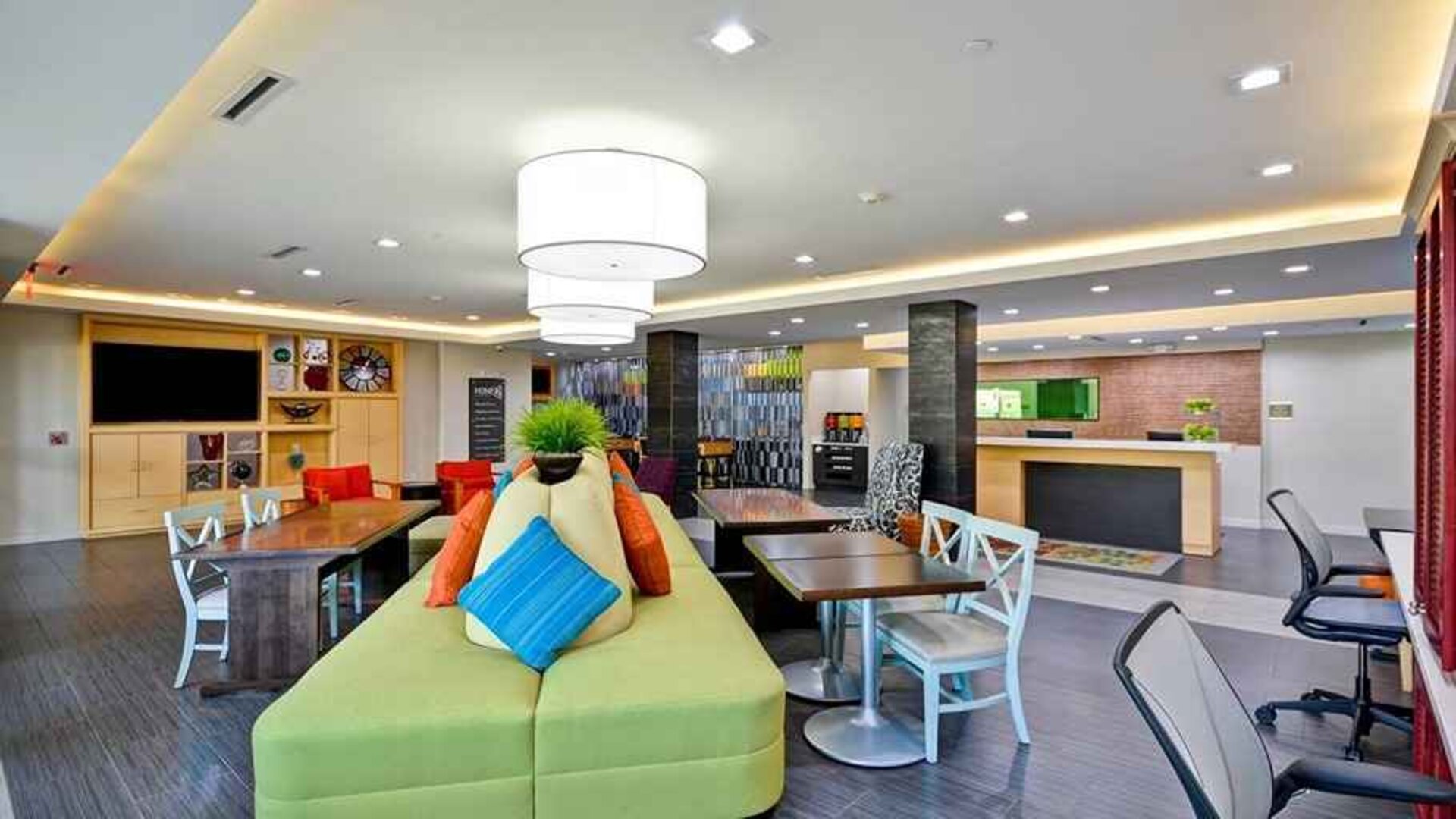 Funky, colorful, and well-lit lobby and coworking space at Home2 Suites by Hilton Fort Worth Southwest Cityview.