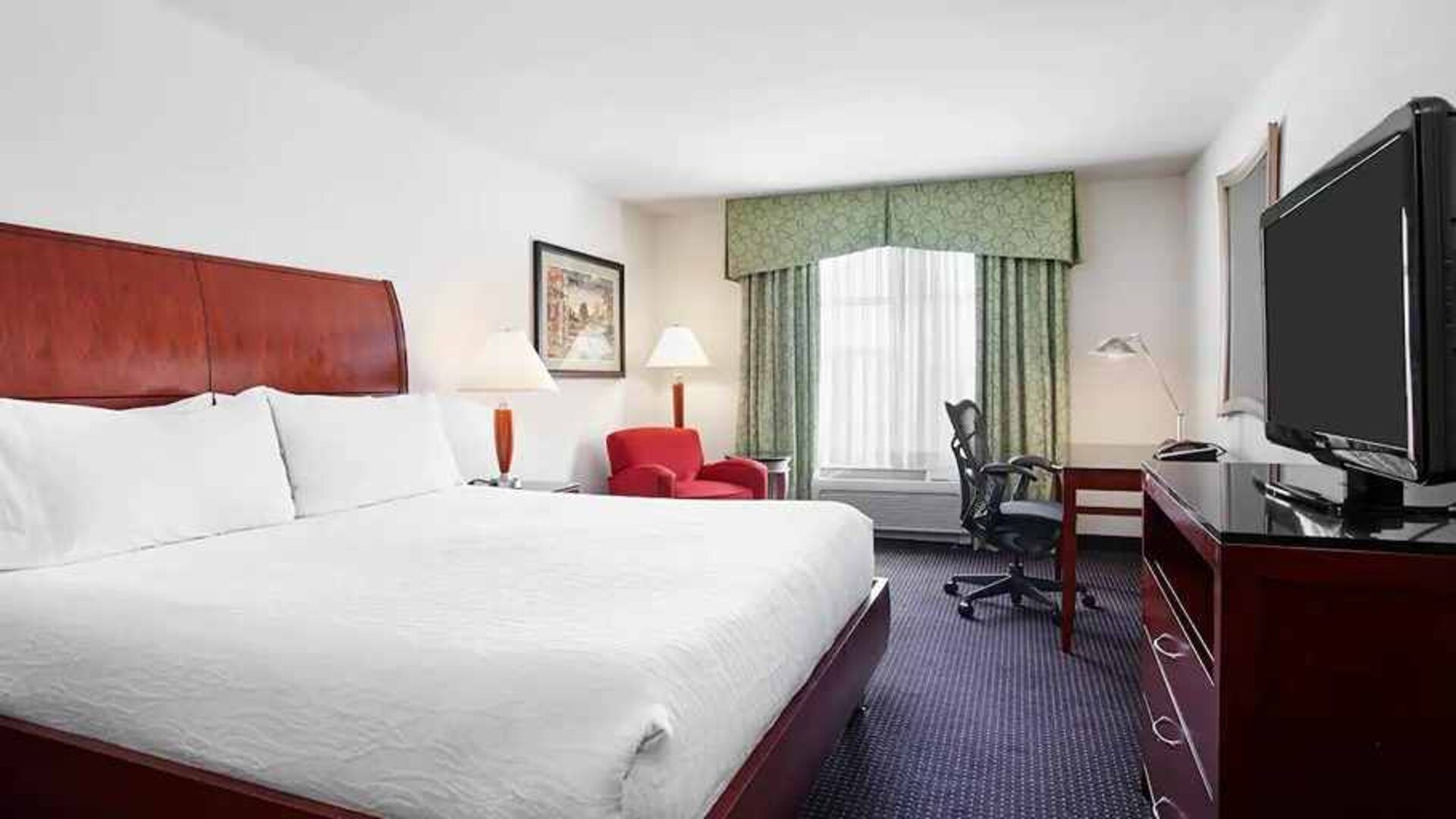 spacious king room with work area and lounge at Hilton Garden Inn Rockville-Gaithersburg.