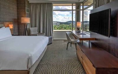 Executive king bedroom with desk, window and TV screen at the Hilton Franklin Cool Springs.
