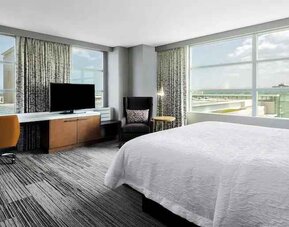 King suite with desk and large windows at the Hilton Garden Inn Chicago McCormick Place.