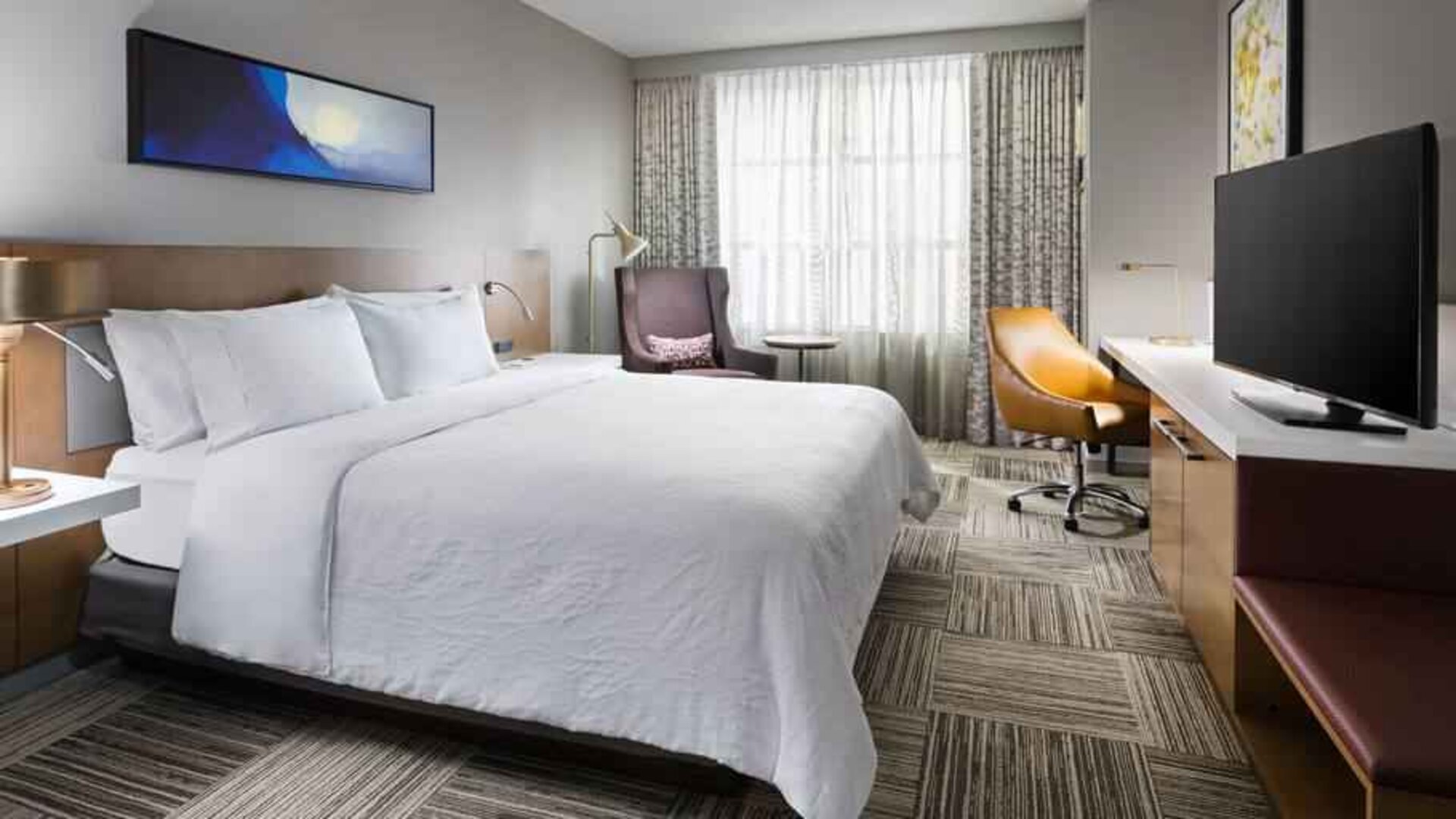 King size bed, TV screen and desk at the Hilton Garden Inn Chicago McCormick Place.