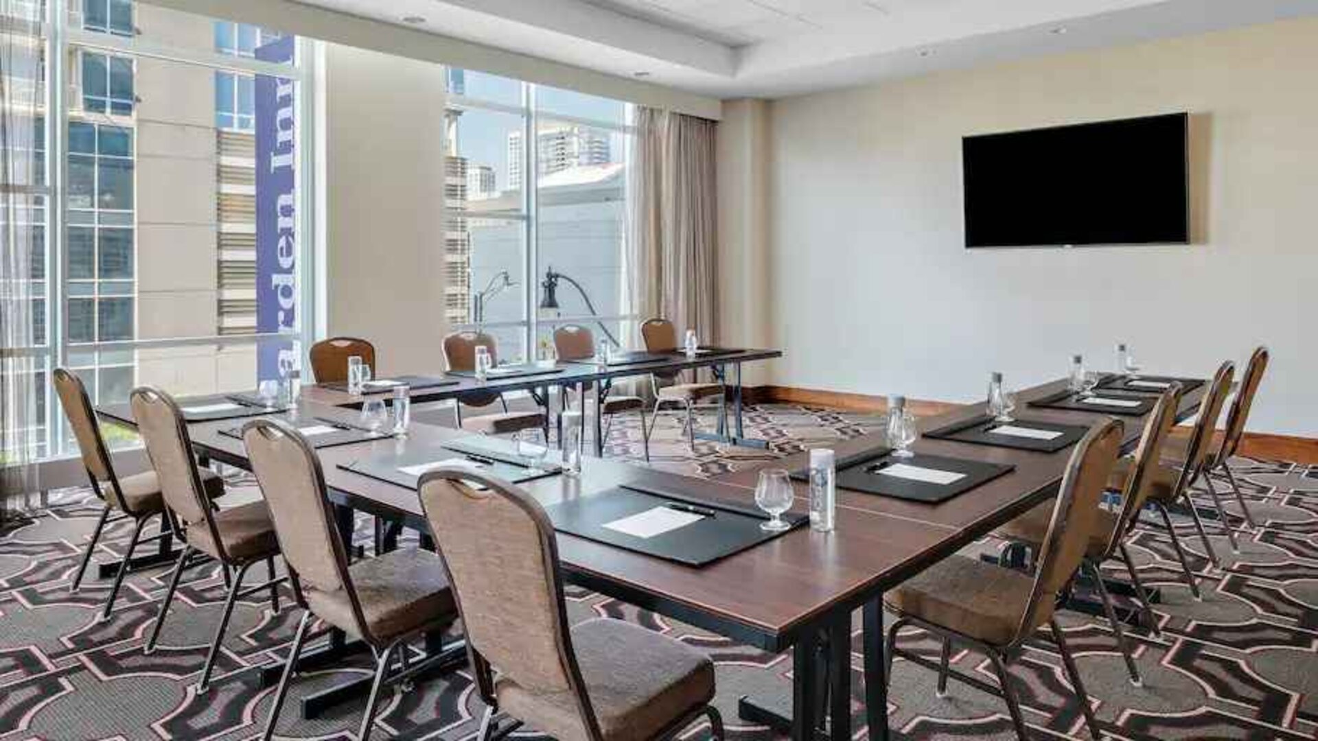Small meeting room with screen at the Hilton Garden Inn Chicago McCormick Place.