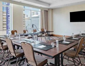 Small meeting room with screen at the Hilton Garden Inn Chicago McCormick Place.