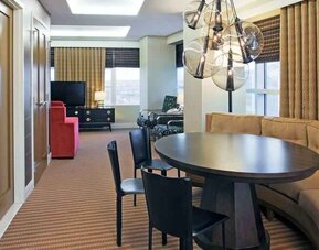 Living room with working station in a hotel suite at the Hilton Omaha.
