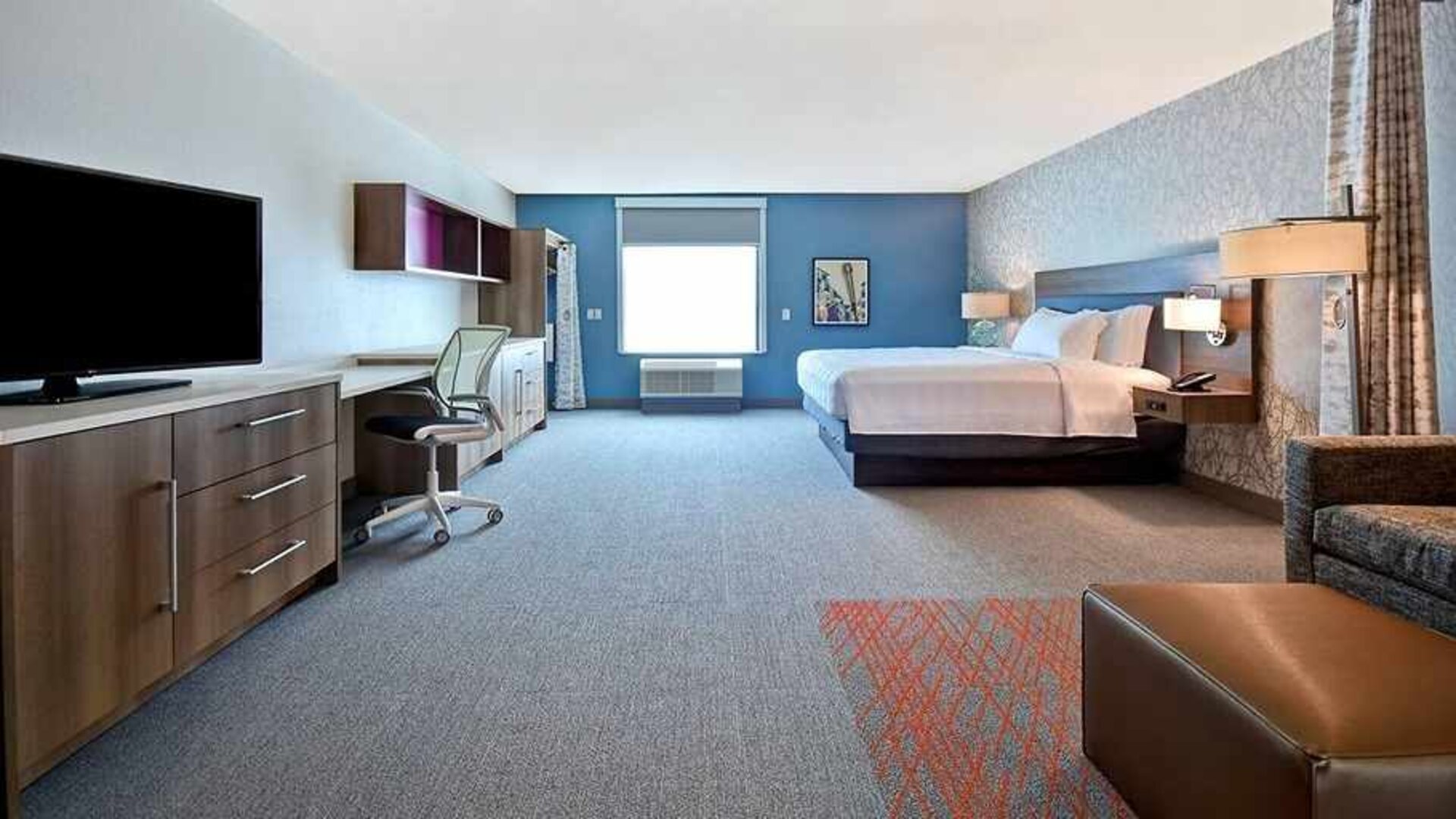 luxurious king suite with work and lounge area at Home2 Suites by Hilton Las Vegas Convention Center.