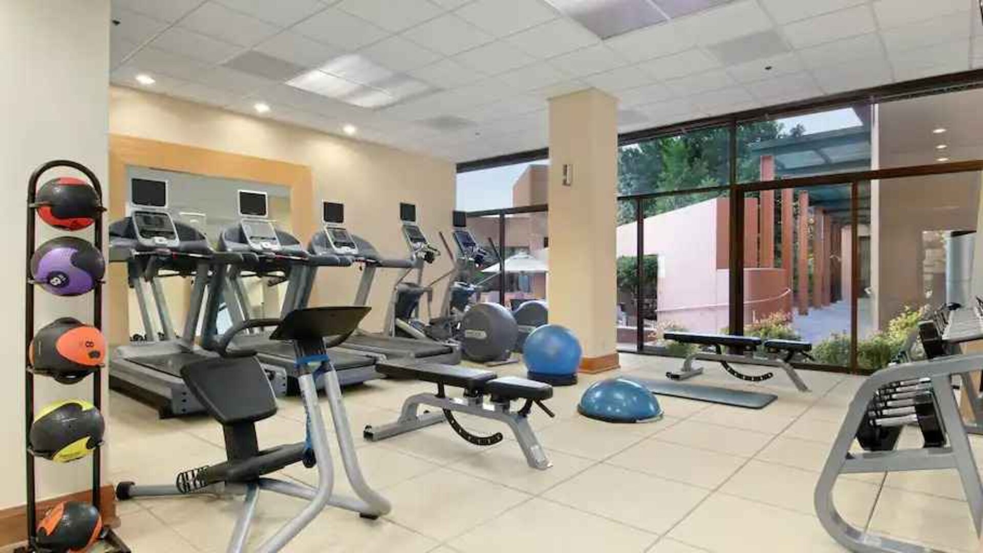 Bright fitness center with treadmills at the Hilton San Antonio-Airport.