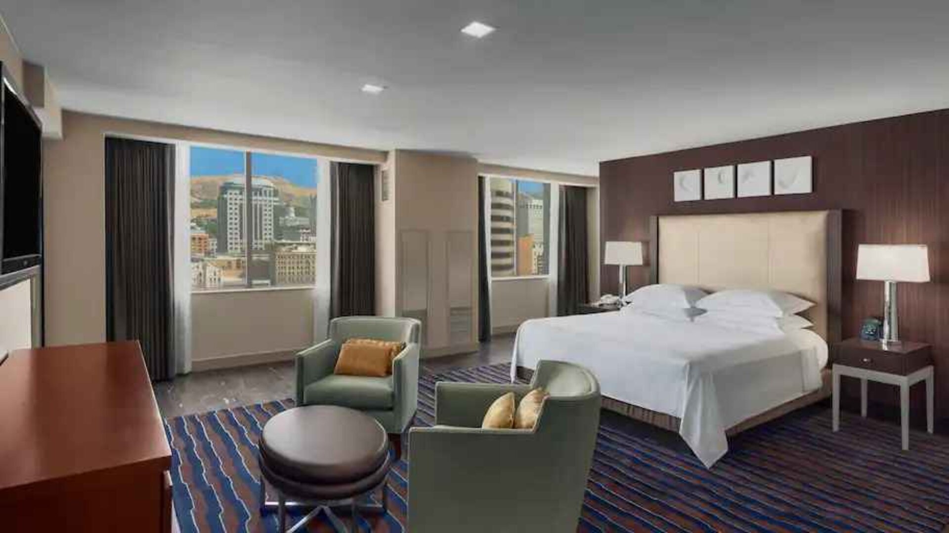 Spacious bedroom with king size bed in a hotel suite at the Hilton Salt Lake City Center.