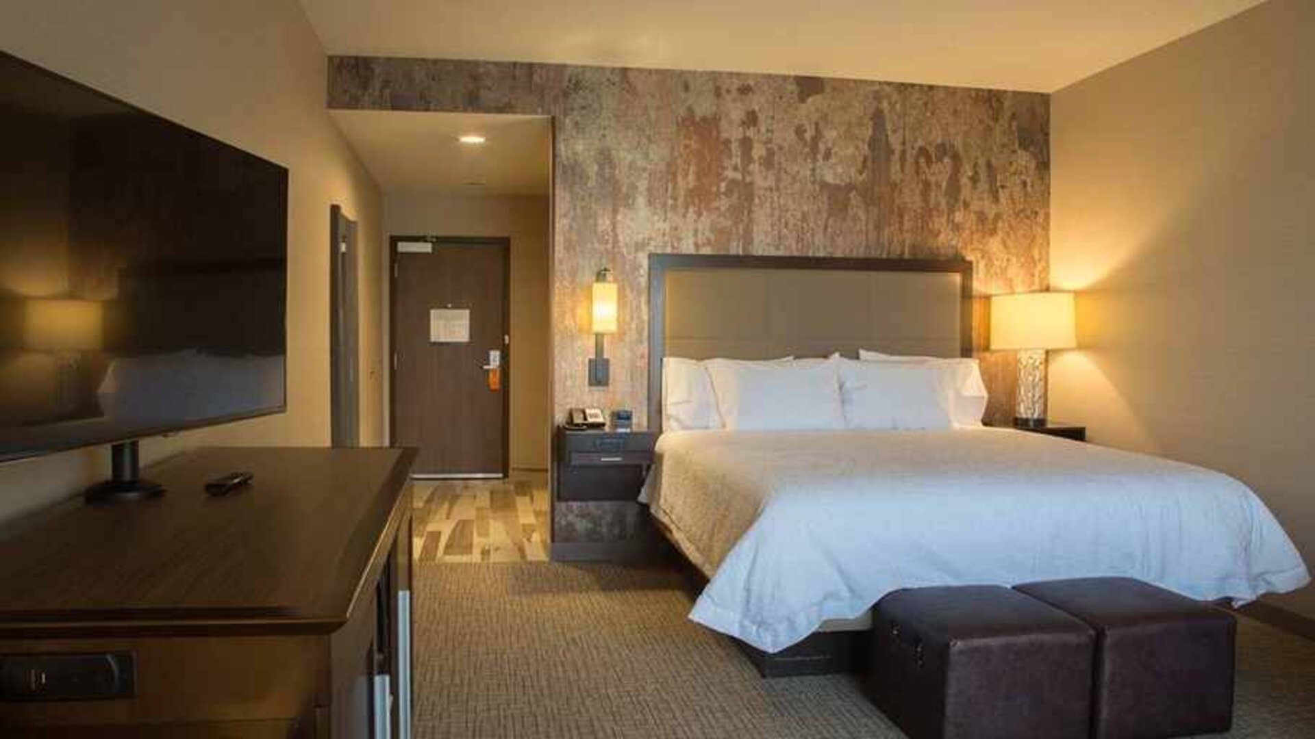 Comfortable king bed with TV at Hampton Inn & Suites Murrieta Temecula.