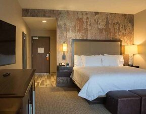 Comfortable king bed with TV at Hampton Inn & Suites Murrieta Temecula.