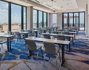 Professional conference room with a lot of natural light and city views at Hilton Garden Inn Austin University.