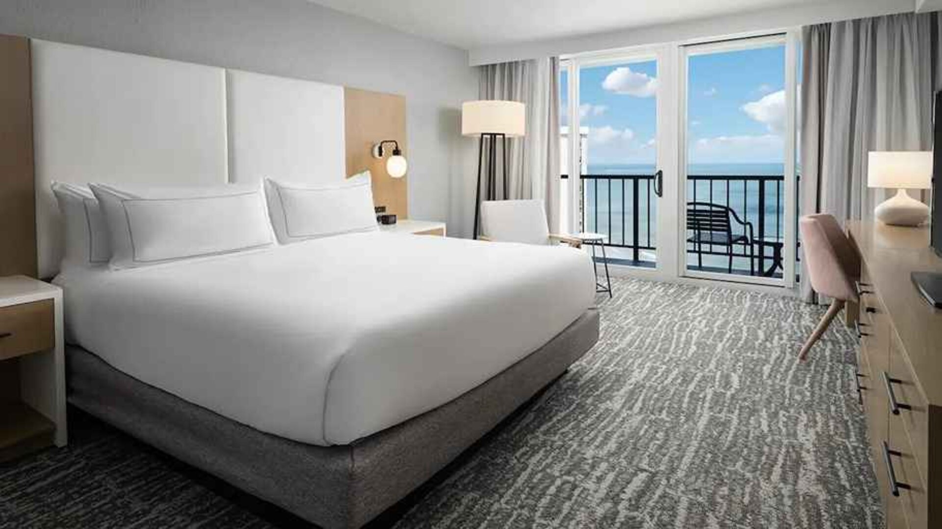 beautiful king room with work area and a terrace with sea views at Hilton Myrtle Beach Resort.