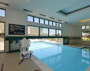 Indoor pool with seating and accessible to otherwise-abled guests at Hampton Inn & Suites Pueblo-Southgate.