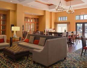 Comfortable lobby lounge area ideal for coworking at Hampton Inn & Suites Pueblo-Southgate.