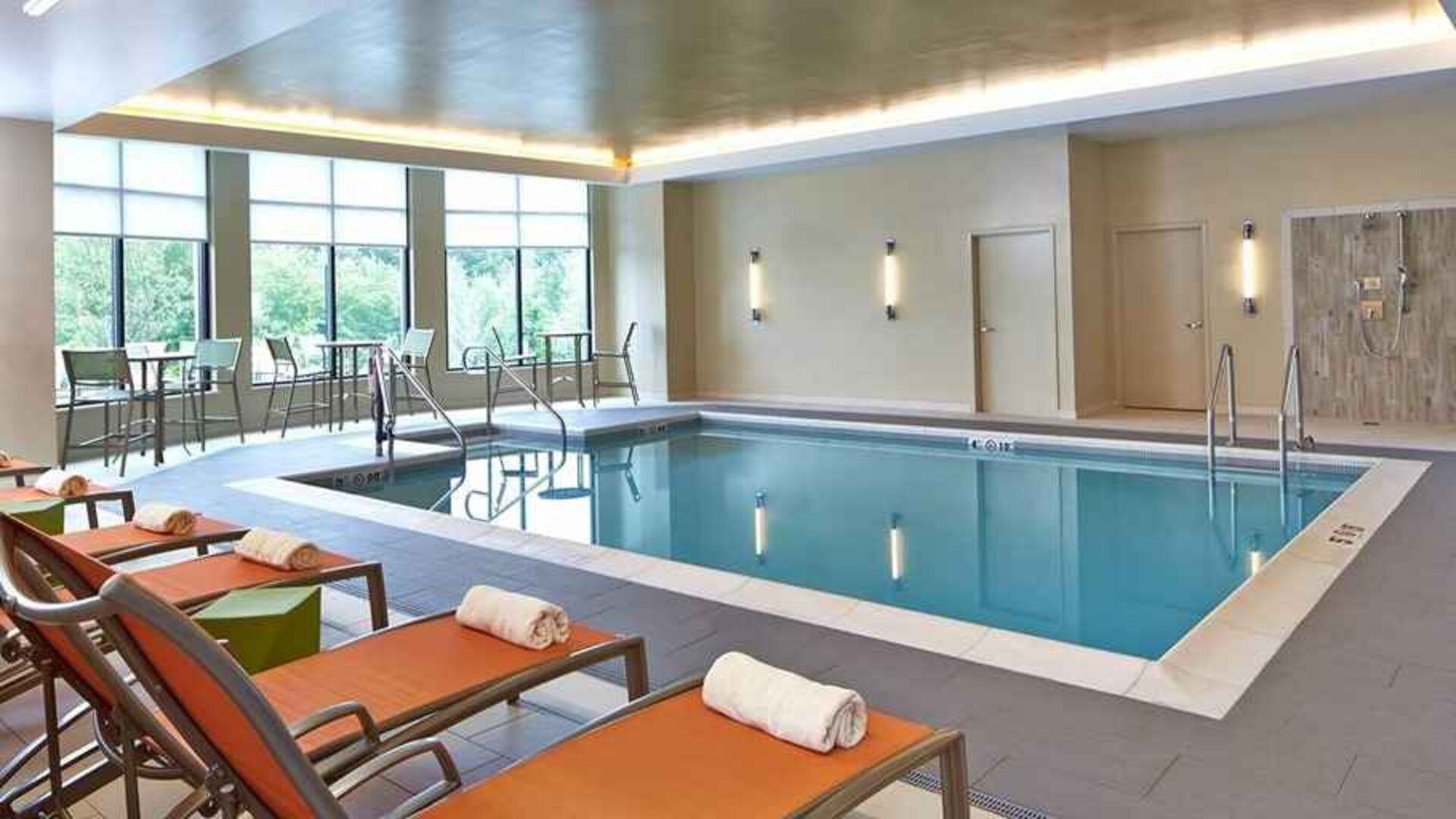 Relaxing indoor pool with comfortable seating at Hilton Garden Inn Boston/Marlborough.