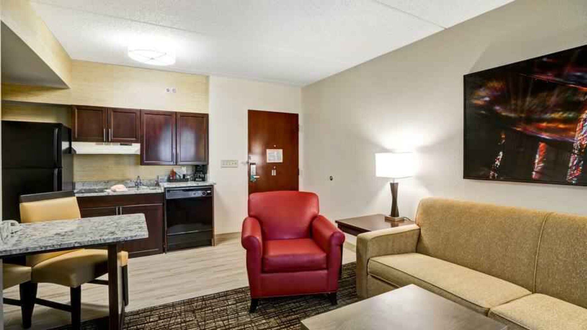 Spacious living room with desk in a hotel suite at the Homewood Suites by Hilton Washington, D.C. Downtown.