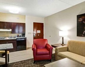 Spacious living room with desk in a hotel suite at the Homewood Suites by Hilton Washington, D.C. Downtown.