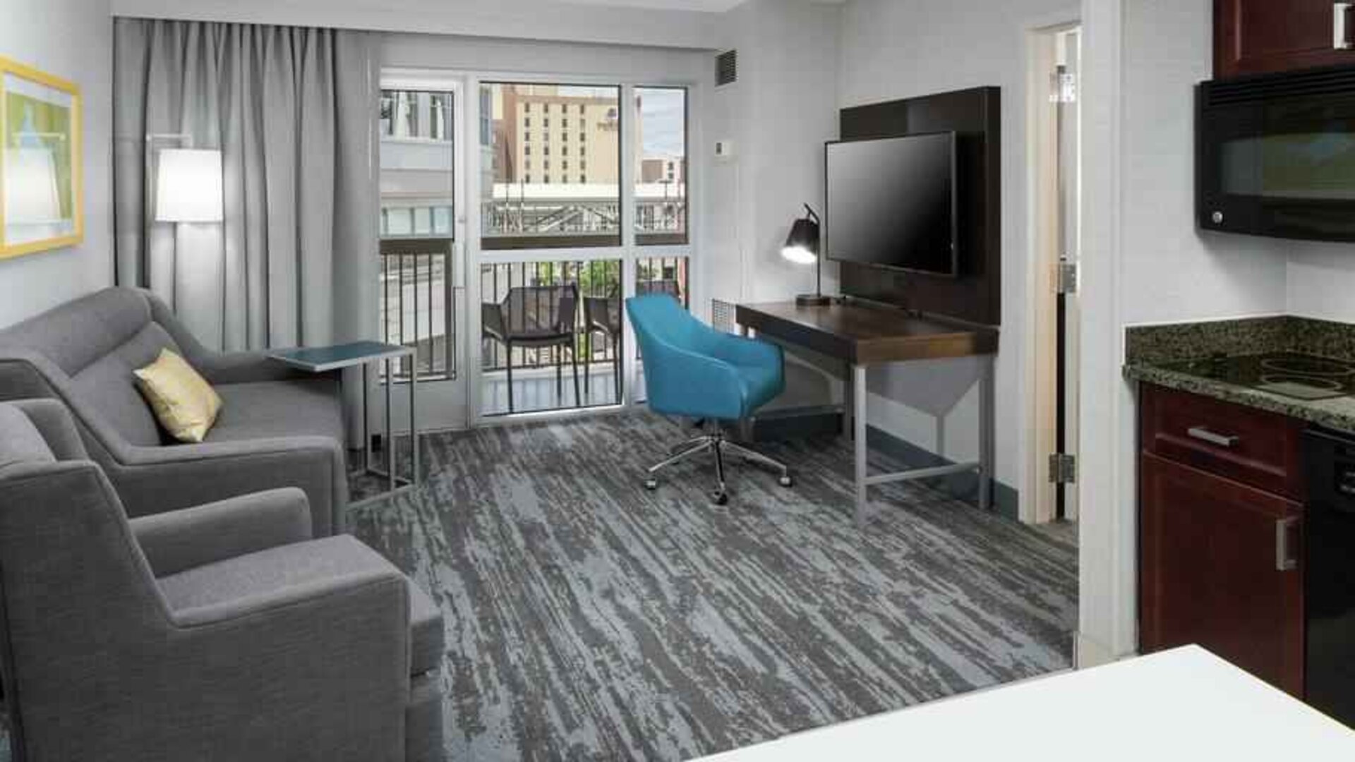 Living room with working station in a hotel suite at the Hampton Inn & Suites Memphis-Beale Street.