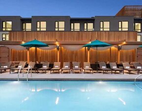 gorgeous outdoor pool with sun beds and seating area at Embassy Suites by Hilton Boulder.