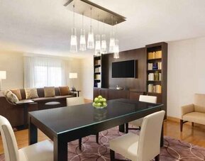 Spacious living room with working station at the Embassy Suites by Hilton Greenville Golf Resort Conference Center