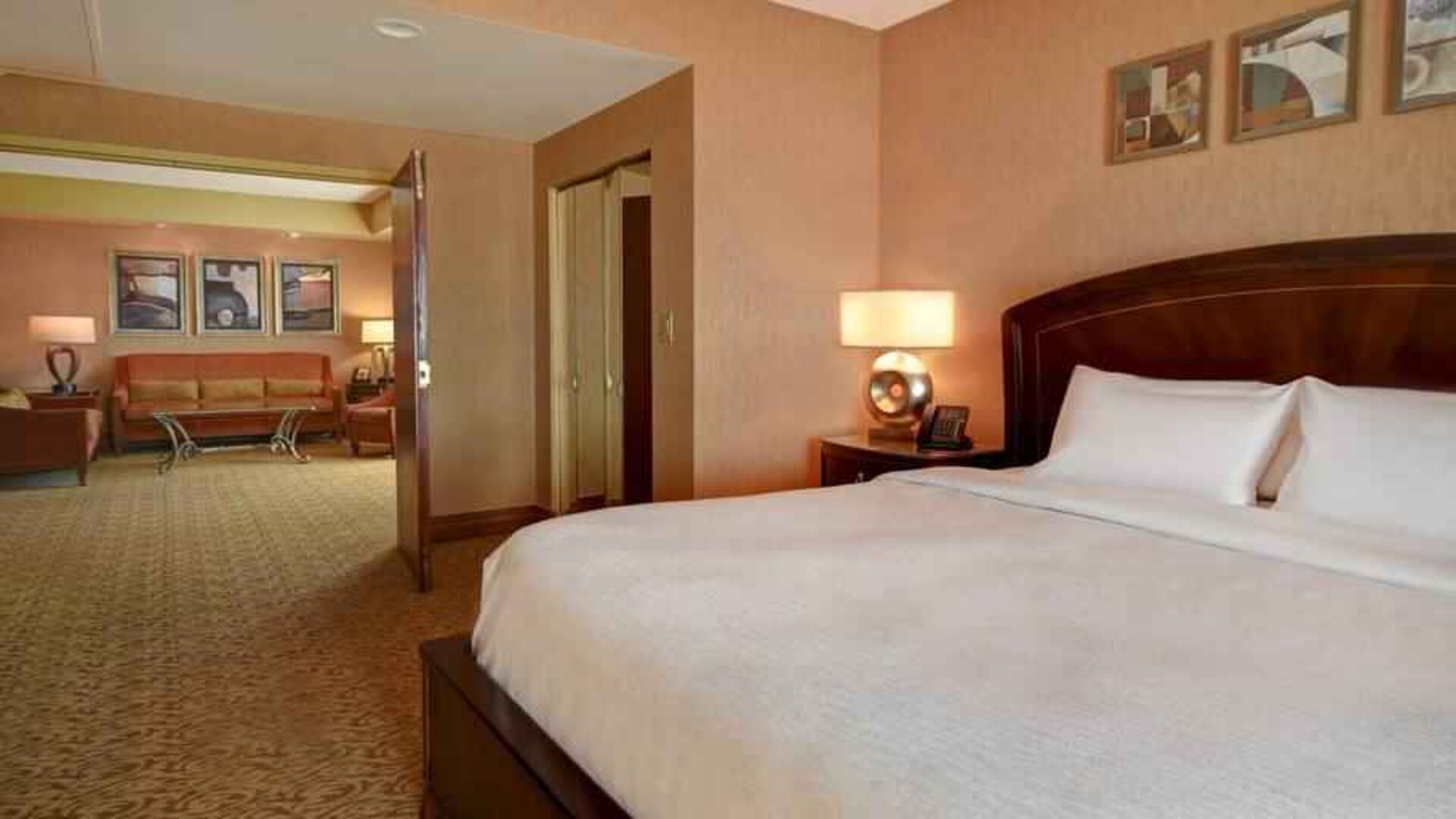 King size bed in a hotel suite at the Embassy Suites by Hilton Hot Springs Hotel & Spa.