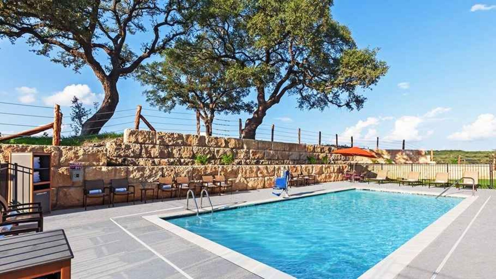 beautiful outdoor pool with comfortable seating area at Hampton Inn Bulverde Texas Hill Country.