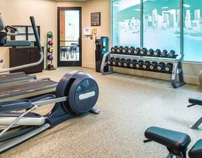 Fully equipped fitness center with treadmills and weights at at Embassy Suites by Hilton Seattle Tacoma International Airport.