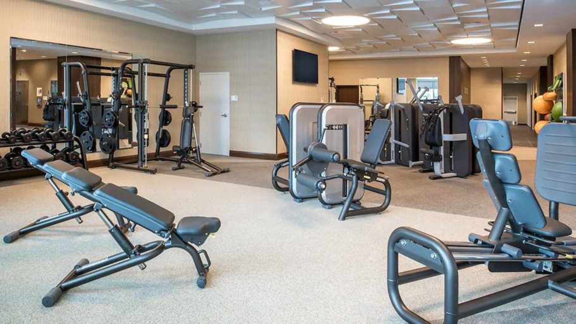 fully equipped fitness center with weights and exercise equipment at Embassy Suites by Hilton Seattle Downtown Pioneer Square.