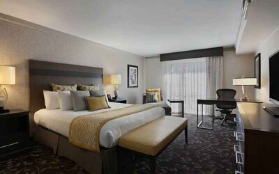 Presidential suite with king size bed and desk at the Embassy Suites by Hilton Napa Valley.