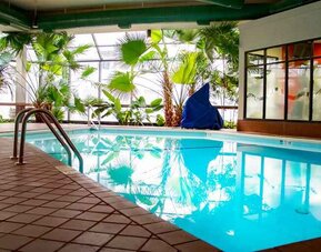 Beautiful indoor pool with plants at the DoubleTree by Hilton Wichita Airport.