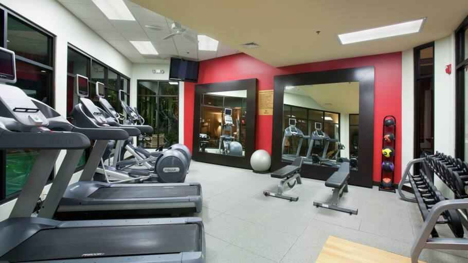 Fitness center with treadmills and weights at the DoubleTree by Hilton Wichita Airport.