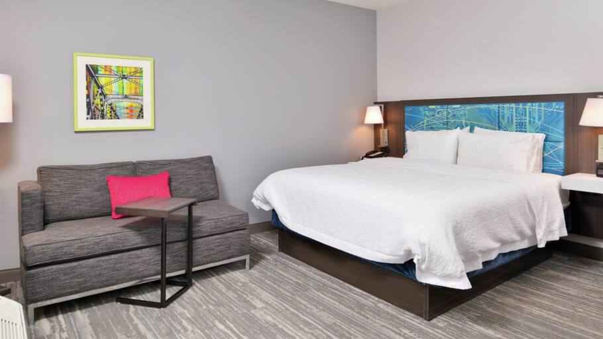 King bedroom with sofa at the Hampton Inn & Suites St. Paul Oakdale/Woodbury by Hilton.