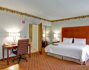 King bedroom with desk at the Hampton Inn & Suites Leesburg.