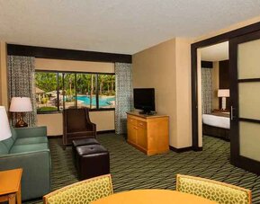 Spacious living room with working station at the DoubleTree Suites by Hilton Orlando - Disney Springs Area.