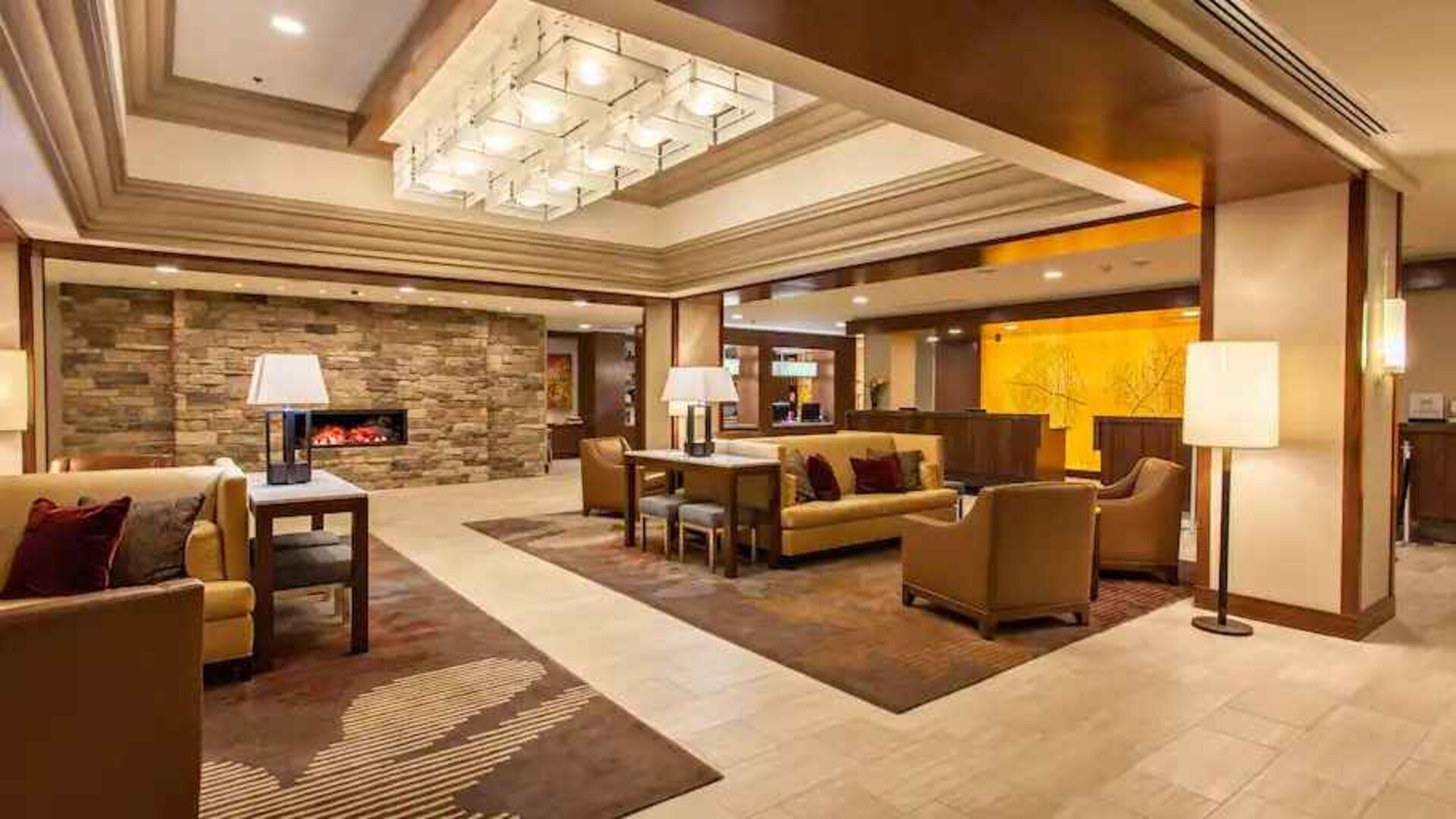 Elegant lobby workspace with sofas and fireplace at the DoubleTree by Hilton Pittsburgh Green Tree.