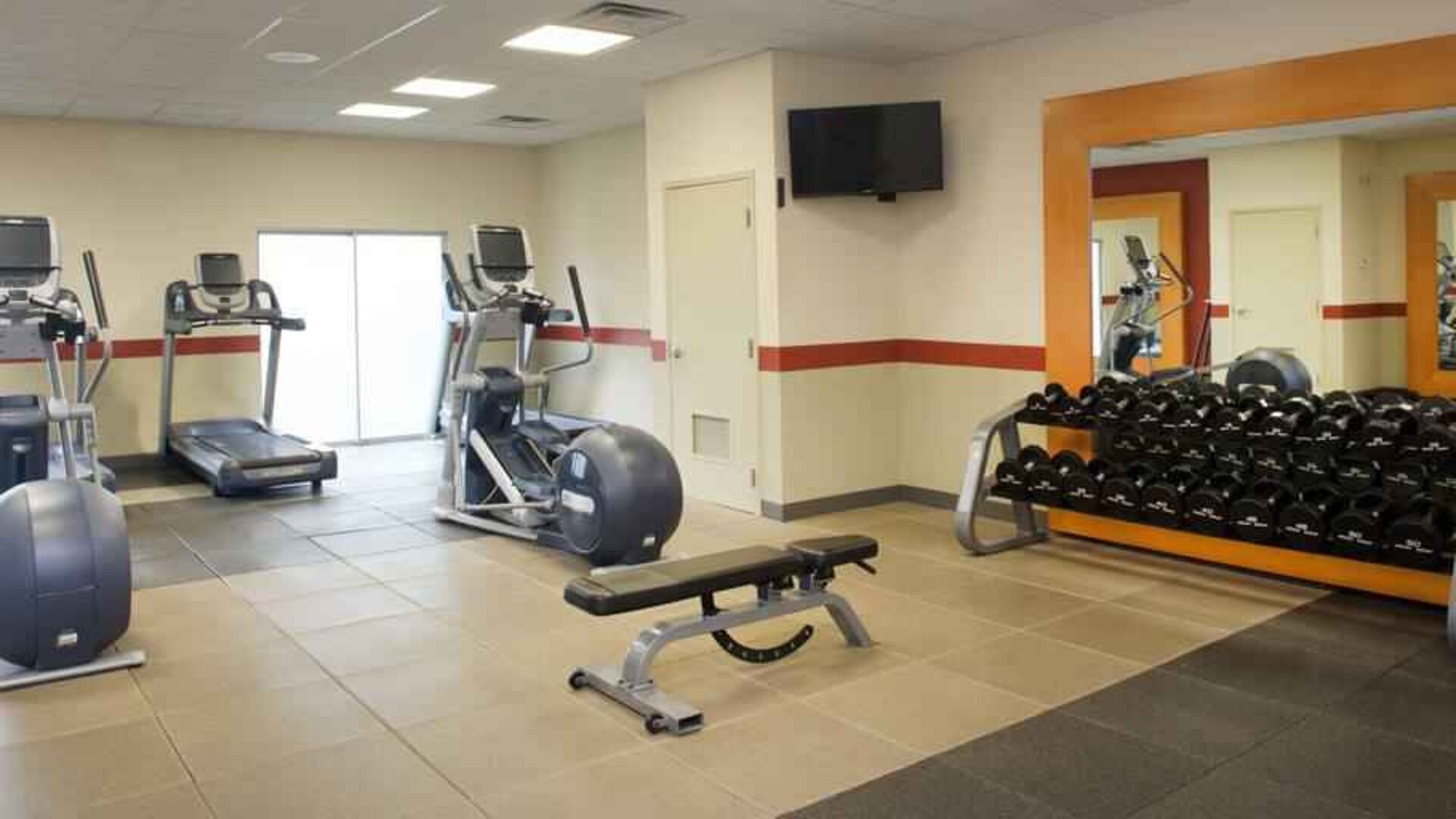 Fitness center with weights at the Embassy Suites by Hilton Cincinnati Blue Ash.