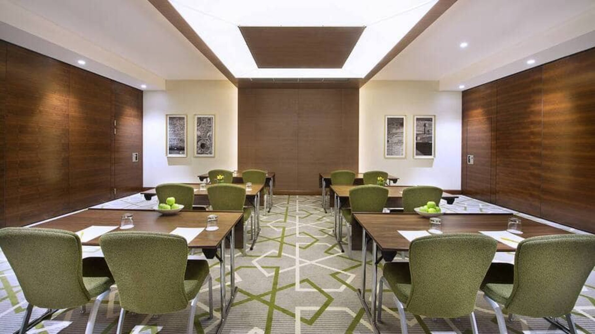 Large coworking or conference meeting room with six tables of four seats each,