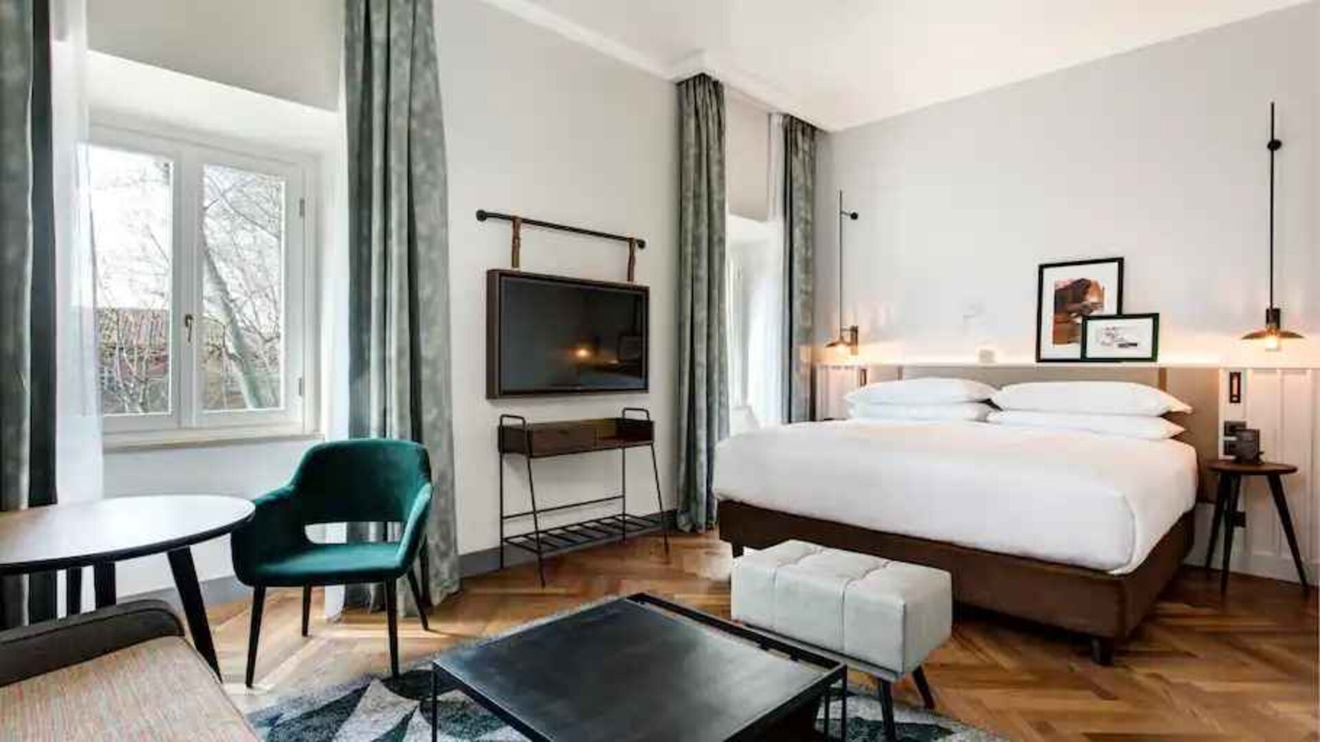 Spacious king bedroom with desk and TV screen at the DoubleTree by Hilton Rome Monti.