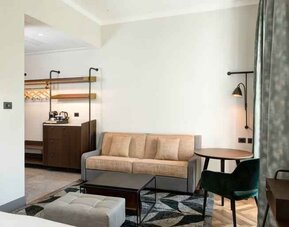 Living room with desk and sofa at the DoubleTree by Hilton Rome Monti.