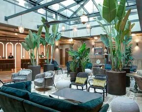 Beautiful lobby workspace with plants at the DoubleTree by Hilton Rome Monti.