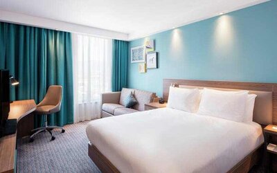 King bedroom with working station at the Hampton by Hilton Belfast City Centre.