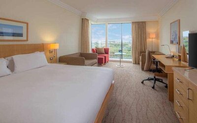 Large king suite with working station at the Hilton Dublin Airport.