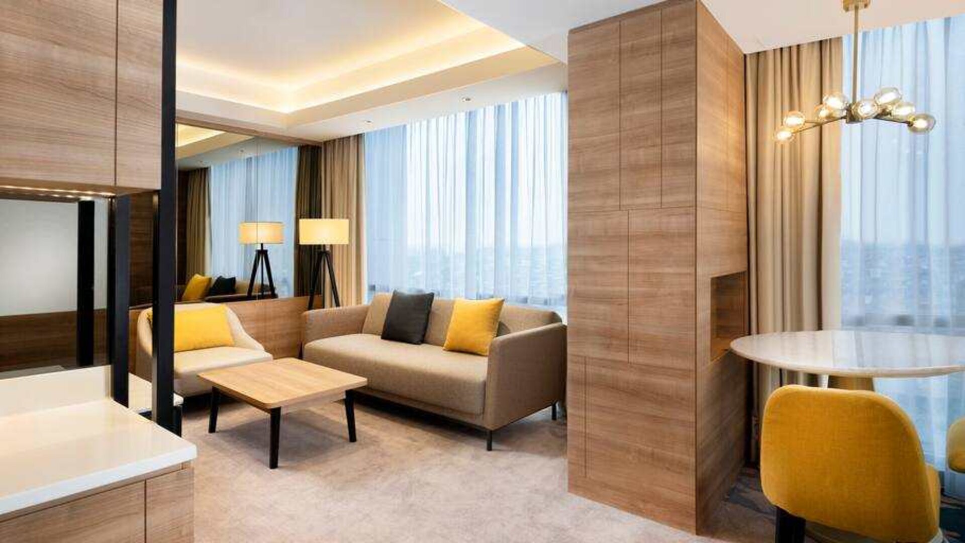 Spacious living room with working station in a king suite at the Hilton Garden Inn Jakarta Taman Palem.