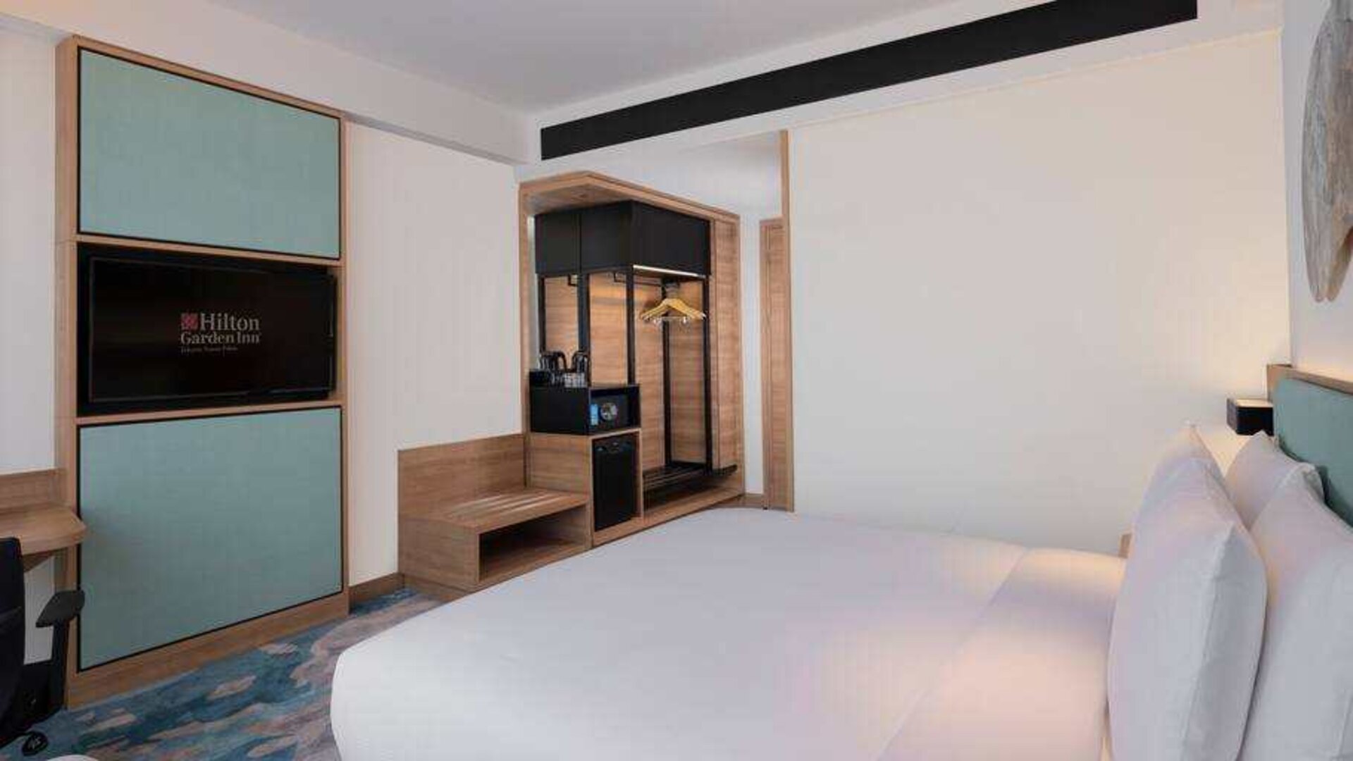 Comfortable king size bed in a king guestroom at the Hilton Garden Inn Jakarta Taman Palem.