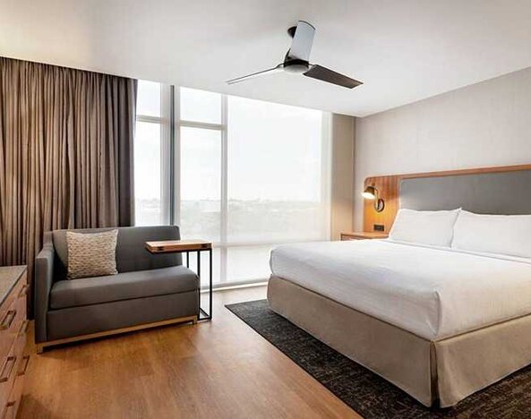 spacious king room with work and lounge area at Homewood Suites by Hilton Wilmington Downtown.